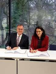 IOI Secretary General Günther Kräuter and APT Chief of Operations Barbara Bernath signing the MoU