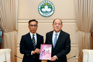Commissioner Chan Tsz King submitting 2022 Annual Report to Chief Executive Ho Iat Seng 